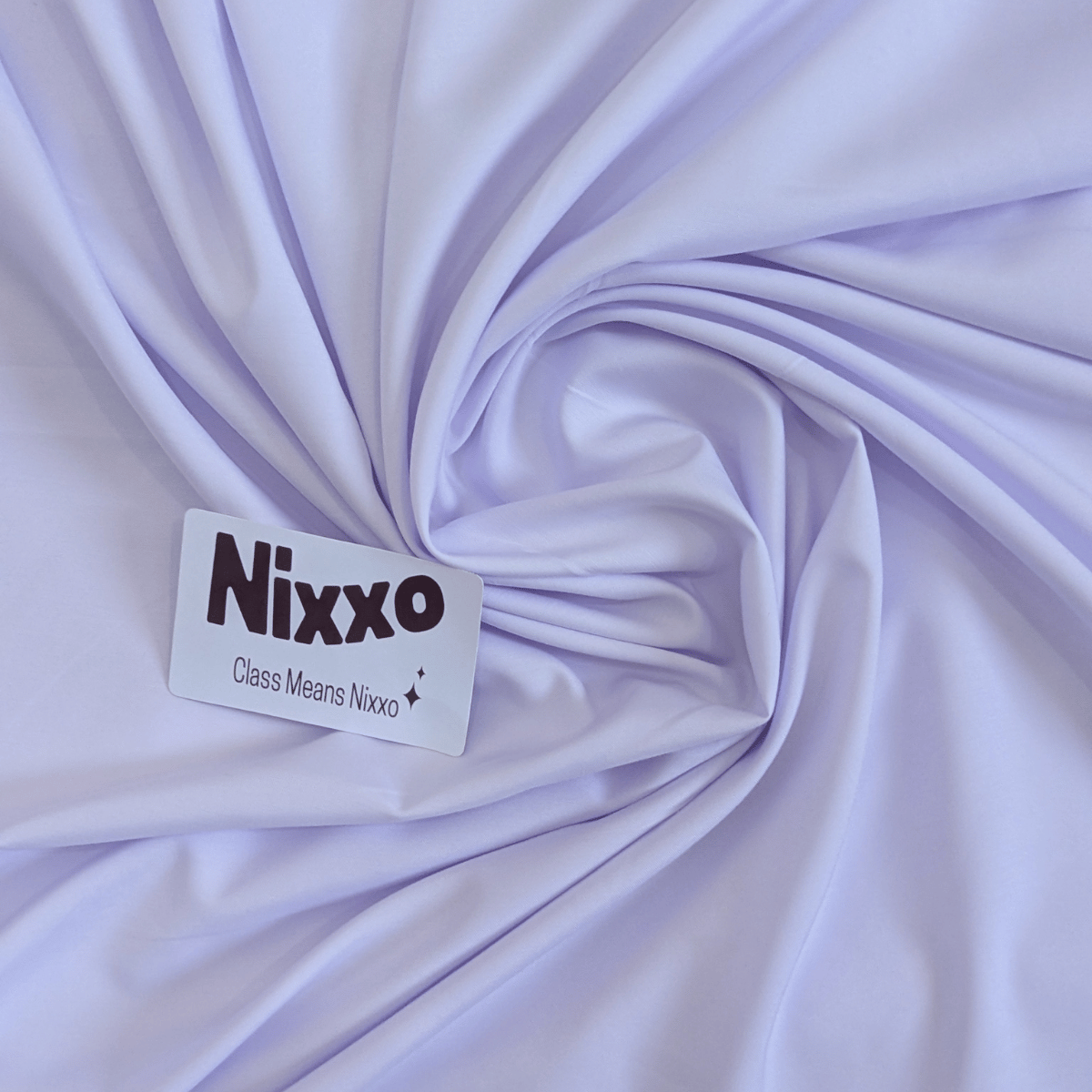 Nixxo label on a swirl of lightWhite Fabrc