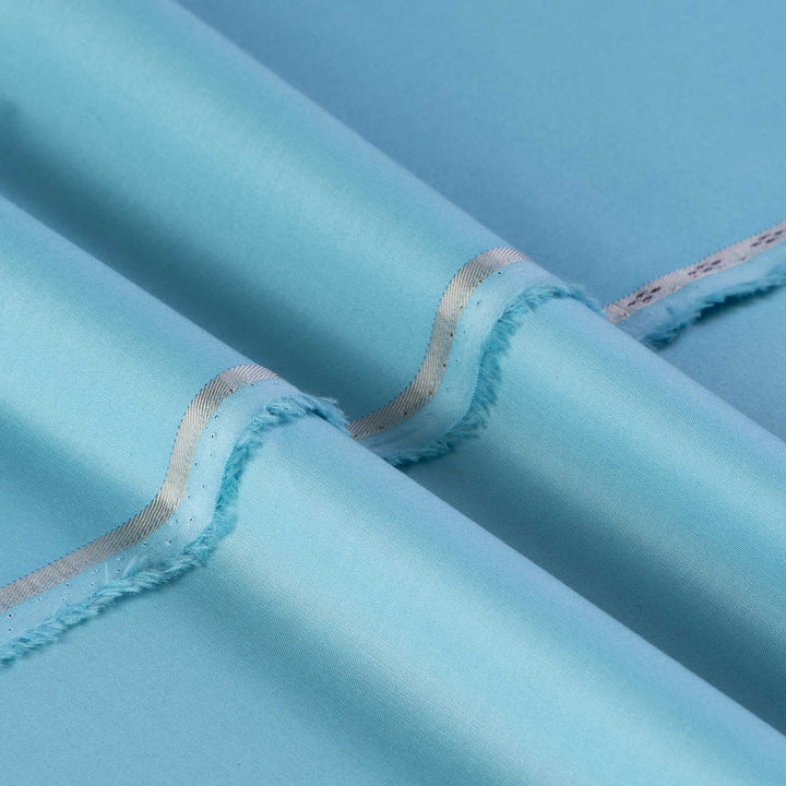 Close-up of light blue fabric with a subtle pattern on a matching background