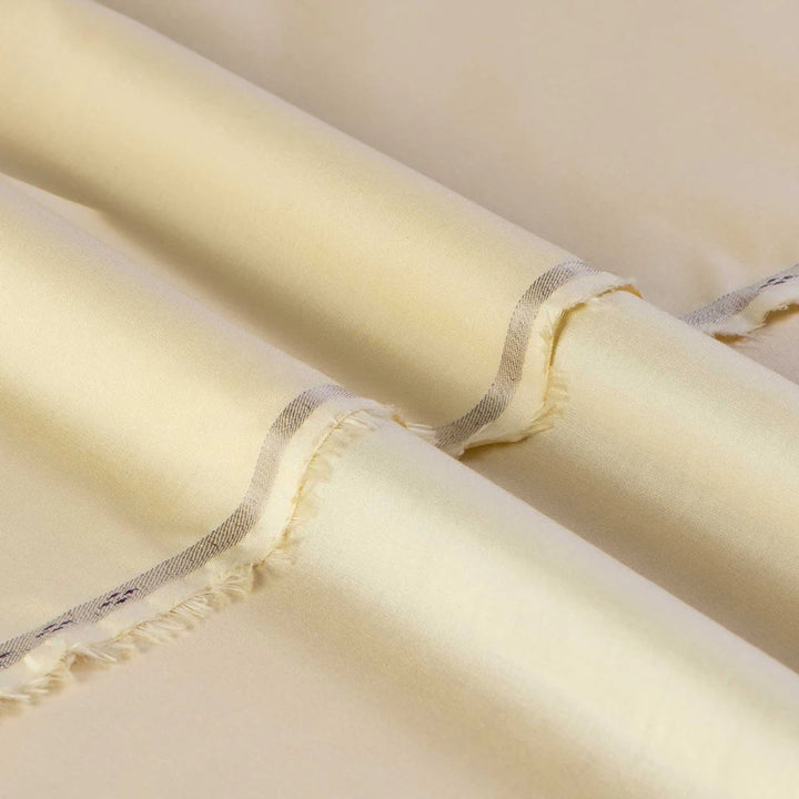 Close-up of beige fabric with a subtle pattern on a beige background