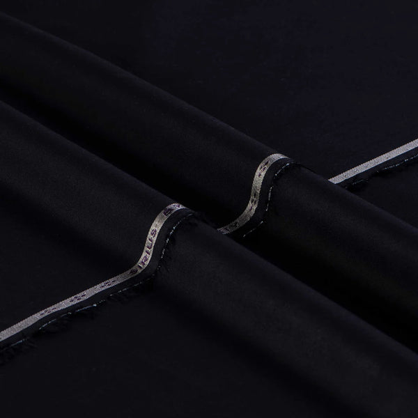 Close-up of black fabric with silver trim on a dark background